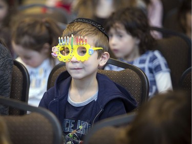 Six-year-old Isaac Lew wears his menorah glasses during Sunday's event.
