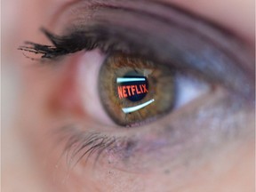 In this photo illustration the Netflix logo is reflected in the eye of a woman.