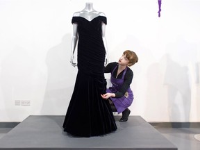 (FILES) In this file photo taken on March 15, 2013, a Victor Edelstein midnight blue velvet evening gown, worn by Britain's Princess Diana at the State Dinner at the White House in 1985, when she danced with US actor John Travolta, is pictured at the Kerry Taylor Auction house in south London ahead of its sale. - A midnight blue velvet gown worn by Princess Diana when she danced with actor John Travolta at the White House is being put up for sale, an auction house said on November 18, 2019. Estimated at £250,000-£350,000 (293,000-410,000 euros, $324,000-$454,000), the dress is one of three being sold by Kerry Taylor Auctions on December 9, 2019.