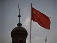 This file photo taken on June 4, 2019 shows the Chinese flag flying over the Juma mosque in the restored old city area of Kashgar in China's western Xinjiang region.