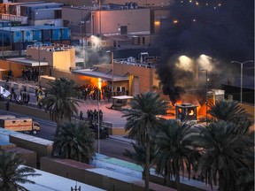 A handout picture received from the U.S. Embassy in Iraq on Dec. 31, 2019, shows smoke billowing from a sentry box at an entrance of the embassy in the capital Baghdad, after supporters and members of the Hashed al-Shaabi military network breached the outer wall of the diplomatic mission during a rally to vent anger over weekend air strikes that killed pro-Iran fighters in western Iraq.