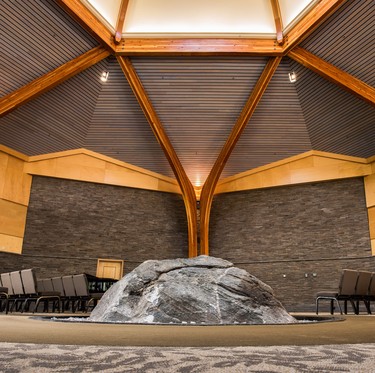 15. THE SACRED SPACE:
One of the most impressive areas inside the Beechwood National Memorial Centre is the awe-inspiring Sacred Space with its soaring ceiling, skylit dome, and wonderful acoustics. Conceived through extensive consultation with local faith leaders and the Ontario Multi-Faith Council, the nine-sided facility serves the commemorative needs of Canadians of diverse backgrounds. At the heart of the Sacred Space lies an ancient weathered boulder, signifying an eternal permanence beyond the transience of human life. The acoustics in the Sacred Space are ideally suited to showcase the baby grand piano that is available for use and kept perfectly tuned.