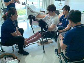 Ryan Straschnitzki sits in a hockey sled while he does physiotherapy in Bangkok, Thailand after spinal surgery a month ago in this handout photo provided by his father. A hockey player paralyzed in the Humboldt Broncos bus crash is thrilled with the progress he's made since receiving spinal surgery in Thailand a month ago.
