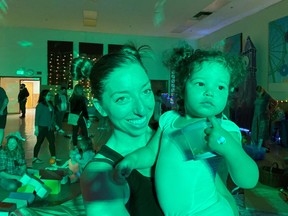 Iliana Hazzard holds her 20-month-old daughter Daphne at a "Baby Rave" in Oakland, California, U.S. November 10, 2019.