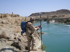 A Canadian construction engineer conducts a survey for a new bridge near the Dahla Dam in Kandahar province of Afghanistan on April 16, 2008.