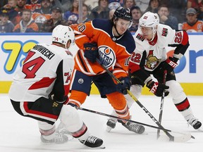 Edmonton Oilers forward Markus Granlund tries to get past Ottawa Senators defensemen Mark Borowiecki and Ottawa Senators defensemen Nikita Zaitsev during the third period at Rogers Place.