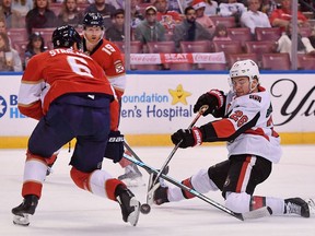 Ottawa Senators Erik Brannstrom shoots the puck off the skate of Florida Panthers Anton Stralman Monday night.
