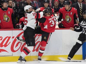 New Jersey Devils center John Hayden (15) fights with Ottawa Senators defenseman Andreas Englund (39) in the first period at the Canadian Tire Centre.