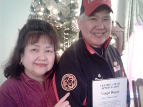 Veteran trucker Vergel Bugay holds his Highway Angel plaque while his wife, Andrea, points to a safe-driving patch. The 67-year-old trucker has logged four million accident-free miles (6.5 million kilometres), and counting