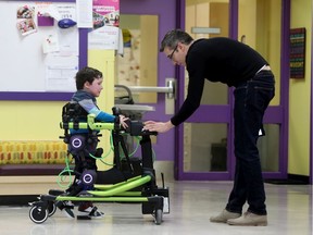 Adam Shales and his son Griffin walking with the Trexo at CHEO  in Ottawa Friday Dec 20, 2019. Griffin is part of study being done at CHEO with Trexo, a robotic device to help people walk. The machine is groundbreaking.