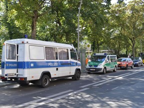 A police car is parked on the side of the road in Berlin, Germany, Aug. 23, 2019. A German teen was found alive in the cupboard of an alleged pedophile, after having been missing for over two years.