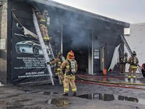 Firefighters at a smoky two-alarm fire on Cleopatra near Merivale.