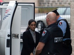 Tooba Mohammad Yahya walks out of the police van at the Frontenac Court courthouse in Kingston Ontario on October 20, 2011.