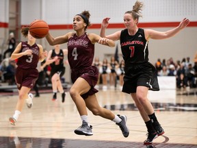 Ottawa's Brooklyn McAlear-Fanus drives to the basket past Carleton's Jaclyn Ronson during an Ontario University Athletics women's basketball game at Carleton on Dec. 4, 2019.