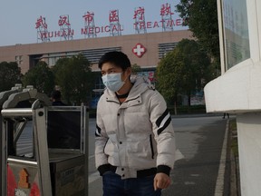 A man leaves the Wuhan Medical Treatment Centre, where a man who died from a respiratory illness was confined, in the city of Wuhan, Hubei province, on January 12, 2020.