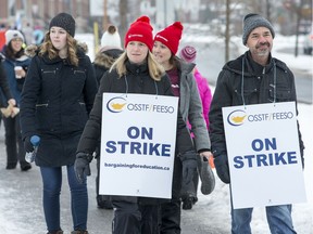 Teachers walk along Longfields Drive in Barrhaven as the OSSTF in Ottawa stage a one-day strike.