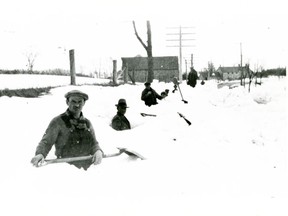 Workers attempt to clear a road near what is now  Ottawa International Airport after a snow storm circa 1935