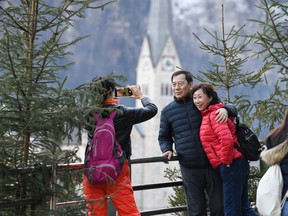 Tourists take photos in the town centre on January 16, 2019 in Hallstatt, Austria. Hallstatt is more recently drawing fans of the movie Frozen.