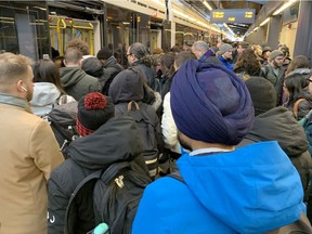People crowd onto a train at Tunney's Pasture station.