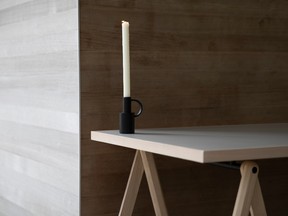 A candlestick that also works as a bud vase sits on a 1.5-metre ash/linoleum trestle table ($418 for the top, $392 per leg.)