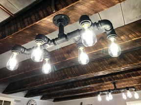 It cost about $30 in hardware to make this light fixture from black iron pipe. Besides providing a creative way to custom-build a vintage look, fixtures like this last forever.
