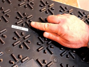 The underside of an air space-type subfloor tile. The raised feet create a sealed air space underneath the waferboard layer.