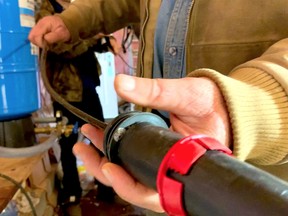 A smart heating cable being installed inside a water supply line on a shallow soil building site.