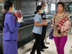 Public Health Officials hand out disease monitoring information after performing a thermal scans on passengers arriving from Wuhan, China at Suvarnabumi Airport on January 8, 2020 in Bangkok, Thailand. Thailand has ordered thermoscanning of passengers in four Thai airports, including Suvarnabumi, Don Mueang, Phuket and Chiang Mai. The disease surveillance and monitoring came about as a response to a severe pneumonia outbreak in Wuhan.