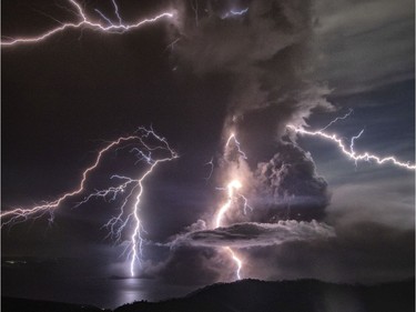 Lightning strikes as a column of ash surrounds the crater of Taal Volcano as it erupts on January 12, 2020 as seen from Tagaytay city, Cavite province, Philippines. Local authorities have begun evacuating residents near Taal Volcano as it began spewing ash up to a kilometer high Sunday afternoon. The Philippine Institute of of Volcanology and Seismology has raised the alert level to four out of five, warning that a hazardous eruption could take place anytime.