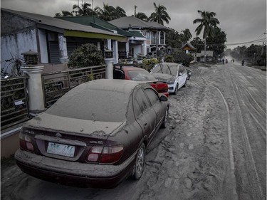 Vehicles covered in volcanic ash from Taal Volcano's eruption are seen on January 13, 2020 in Lemery, Batangas province, Philippines. The Philippine Institute of of Volcanology and Seismology raised the alert level to four out of five, warning that a hazardous eruption could take place anytime, as Manila's international airport suspended flights and authorities began evacuating tens of thousands of people from the area.