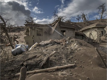 Houses near Taal Volcano's crater is seen buried in volcanic ash from the volcano's eruption on January 14, 2020 in Taal Volcano Island, Batangas province, Philippines. The Philippine Institute of of Volcanology and Seismology raised the alert level to four out of five, warning that a hazardous eruption could take place anytime, as authorities have evacuated tens of thousands of people from the area. An estimated $10 million worth of crops and livestock have been damaged by the on-going eruption, according to the country's agriculture department.