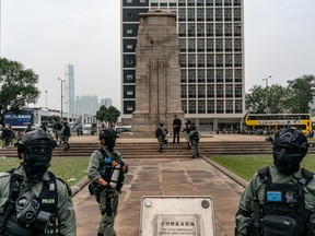 Riot police perform a stop and search on protesters after a Universal Siege On Communists' rally at The Cenotaph in Central district on January 19, 2020 in Hong Kong, China.