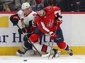 Nick Jensen (3) of the Capitals closes off and Rudolfs Balcers of the Senators along the boards during a battle for the puck in the first period of Tuesday's game in Washington.