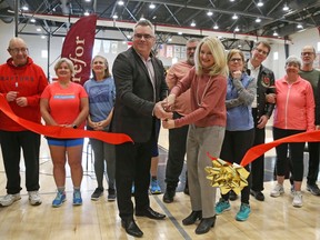 Carefor CEO Steve Perry (L) and Jennifer Brenning, Director, Recreation and Athletics for Carleton University, cut the ribbon for the launch of a new young onset dementia program called The Club to be held at Carleton University.