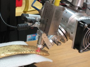 An X-ray detector scans a large gold bar found decades ago in downtown Mexico City is seen in this handout photograph released to Reuters by the National Institute of Anthropology and History (INAH) on Jan. 9, 2020. (National Institute of Anthropology and History/Handout via REUTERS)