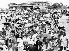 This file picture from Agence Khmere de Presse, taken in the days after Khmer Rouge forces seized the Cambodian capital in 1975, shows Cambodians walking with their belongings as they leave Phnom Penh after the communist regime ordered the city's two million people to evacuate.