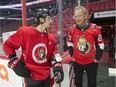 Senators owner Eugene Melnyk chats with defenceman Thomas Chabot, left, during the annual Eugene Melnyk Skate for Kids at Canadian Tire Centre on Dec. 20.