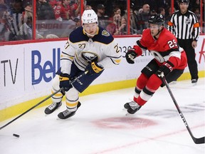 Curtis Lazar is chased by Cody Goloubef in the second period as the Ottawa Senators take on the Buffalo Sabres in NHL action at the Canadian Tire Centre in Ottawa on Dec. 23, 2019.