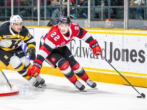 Jack Quinn, who scored three goals for the 67's on Thursday, is pursued by Lucas Peric of the Frontenacs as he skates behind the net with the puck.