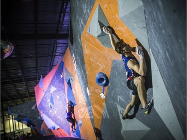 The finals for the 2020 CEC Open Boulder Nationals were held Sunday at Altitude climbing gym in Kanata. Finn Battersby of British Columbia competes Sunday afternoon as Justine McCarney of Ontario works on her problem.