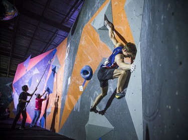 The finals for the 2020 CEC Open Boulder Nationals were held Sunday at Altitude climbing gym in Kanata. Finn Battersby of British Columbia competes Sunday afternoon as Justine McCarney of Ontario works on her problem.