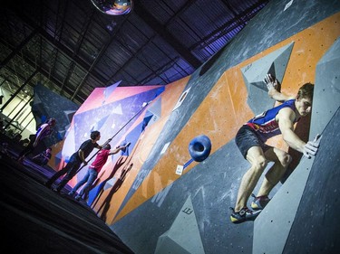 The finals for the 2020 CEC Open Boulder Nationals were held Sunday at Altitude climbing gym in Kanata. Finn Battersby of British Columbia competes Sunday afternoon as Justine McCarney of Ontario works on her problem.