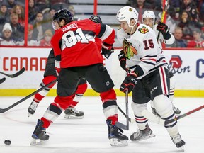 Former Senator Zack Smith, right, battles with Ron Hainsey for the puck during the second period of Tuesday's game.