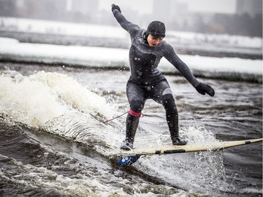 A couple experienced surfers, including Magalie Rondeau, pulled on their wetsuits, packed some thermos' of hot drinks and got together to enjoy the Sewer Wave on the Ottawa River on Sunday.