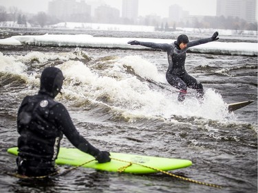 A couple experienced surfers, including Magalie Rondeau, pulled on their wetsuits enjoyed surfing on Sunday on the Ottawa River.