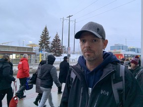 Rob Maybee, waiting for his bus after transferring from the train at Blair Station.