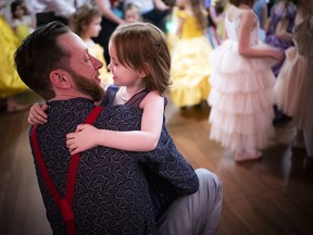 Mike Cheverton with his daughter, four-year-old Lily, take a moment before they hit the dance floor for a father-daughter dance.