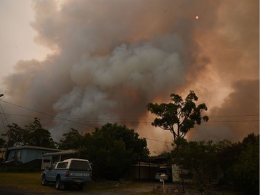 A fire burns from back burning as firefighters prepare ahead of a fire front in the New South Wales town of Jerrawangala on January 1, 2020. - A major operation to reach thousands of people stranded in fire-ravaged seaside towns was under way in Australia on January 1 after deadly bushfires ripped through popular tourist spots and rural areas leaving at least eight people dead.