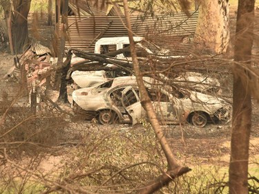 Cars destroyed by bushfires are seen in Mogo near Batemans Bay in New South Wales on January 2, 2020. - Australia authorised the forced evacuation of residents on January 2 amid a mass exodus of tourists from fire-ravaged coastal communities, as the country braces for a weekend heatwave expected to fan deadly bushfires.