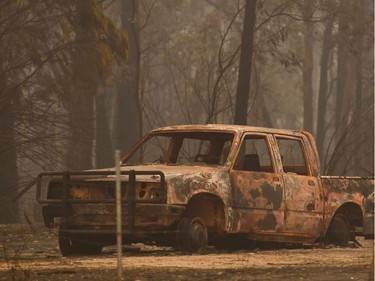 A burnt out car is seen in an area devastated by bushfires in Sarsfield, Victoria state on January 3, 2020. - Australia ordered residents and tourists out of the path of raging bushfires on January 3 as the country braced for a weekend heatwave expected to fan the deadly inferno.